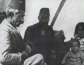 An Armenian family sitting in a tent inside a refugee