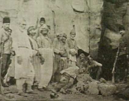 The Armenian committee member (Mardo), Tigris from Diarbekir, posing in front of the Turkish villager they killed.